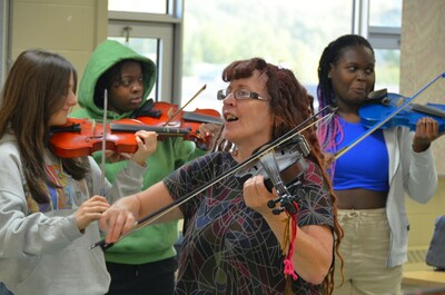 Linda Duford of the Kole Crook Fiddle Association teaches Grade 10 to 12 Aboriginal Studies students the traditional art of Metis fiddling
